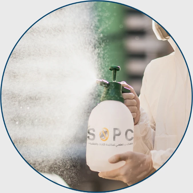 disinfection specialist in PPE suit performing spray